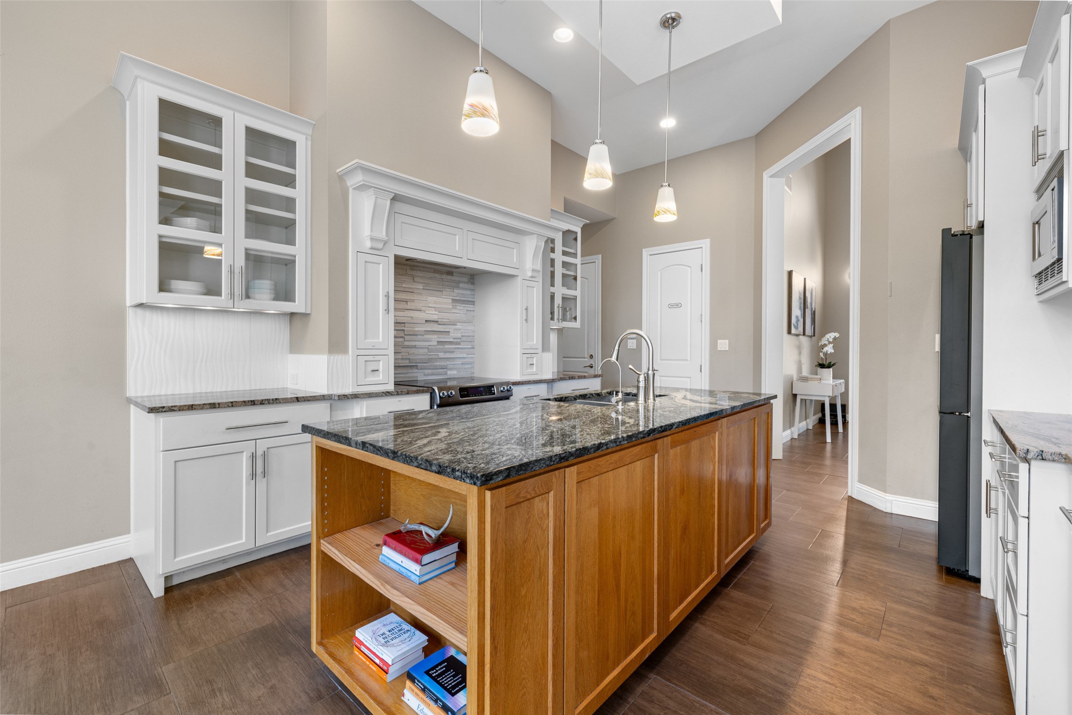 1017 South Quinlan Park Road Austin, TX 78732 - Photo 14 of 39 a kitchen with granite countertop a sink and cabinets