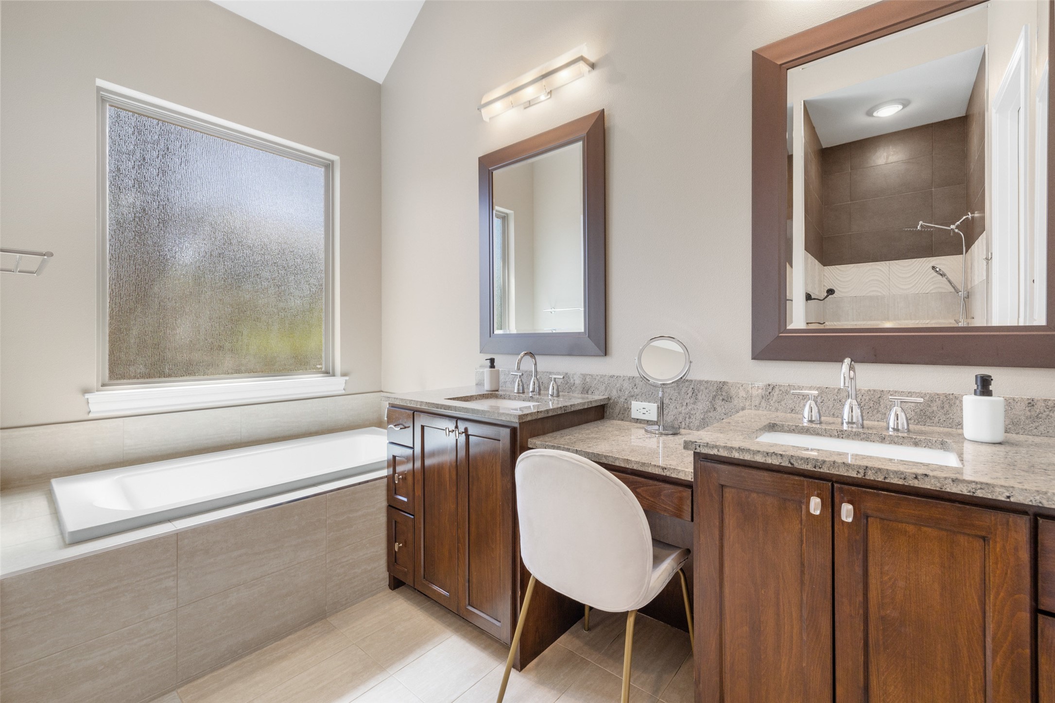 1017 South Quinlan Park Road Austin, TX 78732 - Photo 18 of 39 a bathroom with a granite countertop sink a mirror and a bathtub