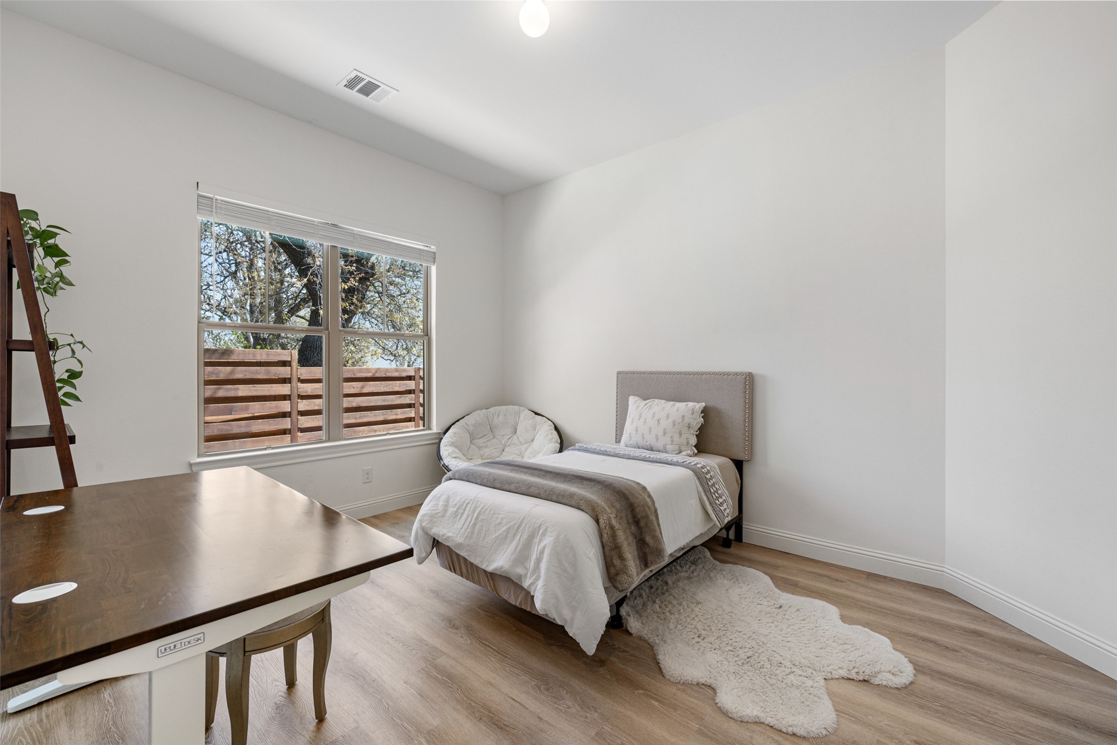 1017 South Quinlan Park Road Austin, TX 78732 - Photo 22 of 39 a bedroom with a bed and a desk