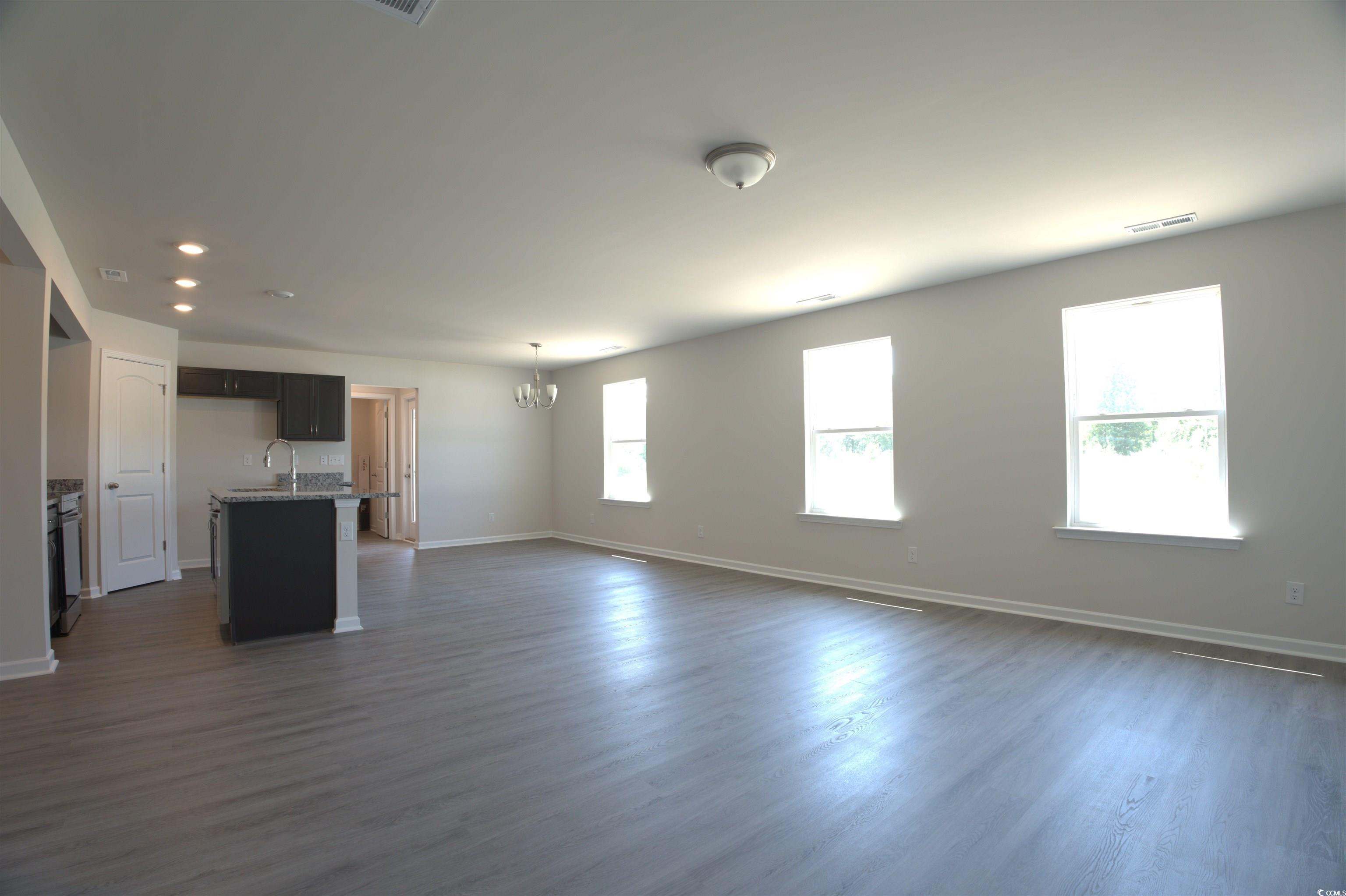 2668 Tansy Road Loris, SC 29569 - Photo 2 of 11 Unfurnished living room featuring a chandelier, dark wood-style floors, and recessed lighting