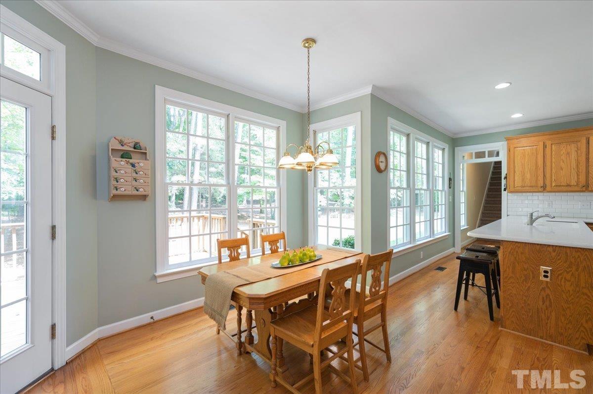 7025 Spring Ridge Road Cary, NC 27518 - Photo 12 of 35 a dining room with furniture window wooden floor