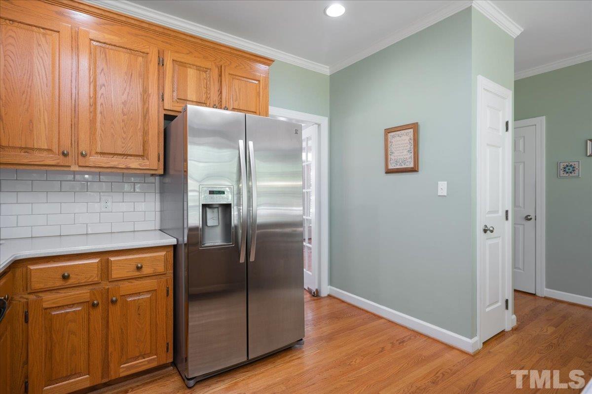 7025 Spring Ridge Road Cary, NC 27518 - Photo 17 of 35 a kitchen with stainless steel appliances granite countertop a refrigerator and a stove