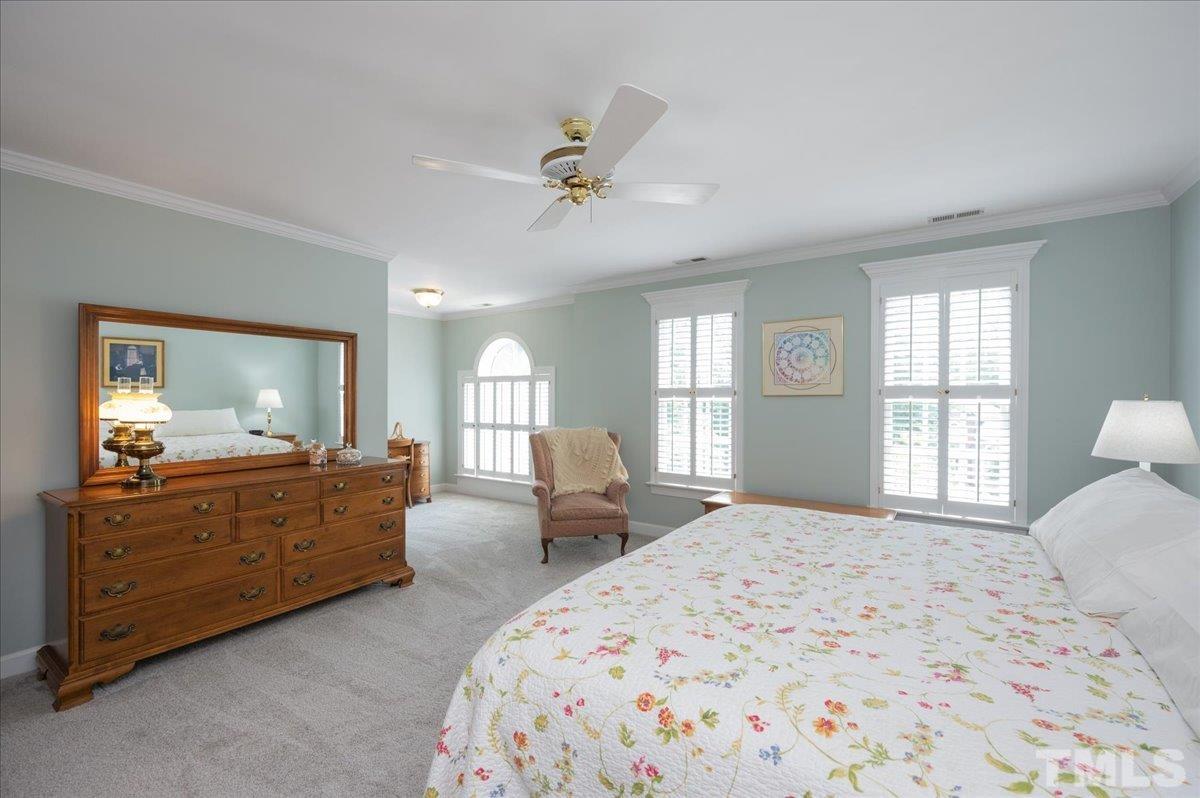 7025 Spring Ridge Road Cary, NC 27518 - Photo 19 of 35 a bedroom with a bed and wooden floor