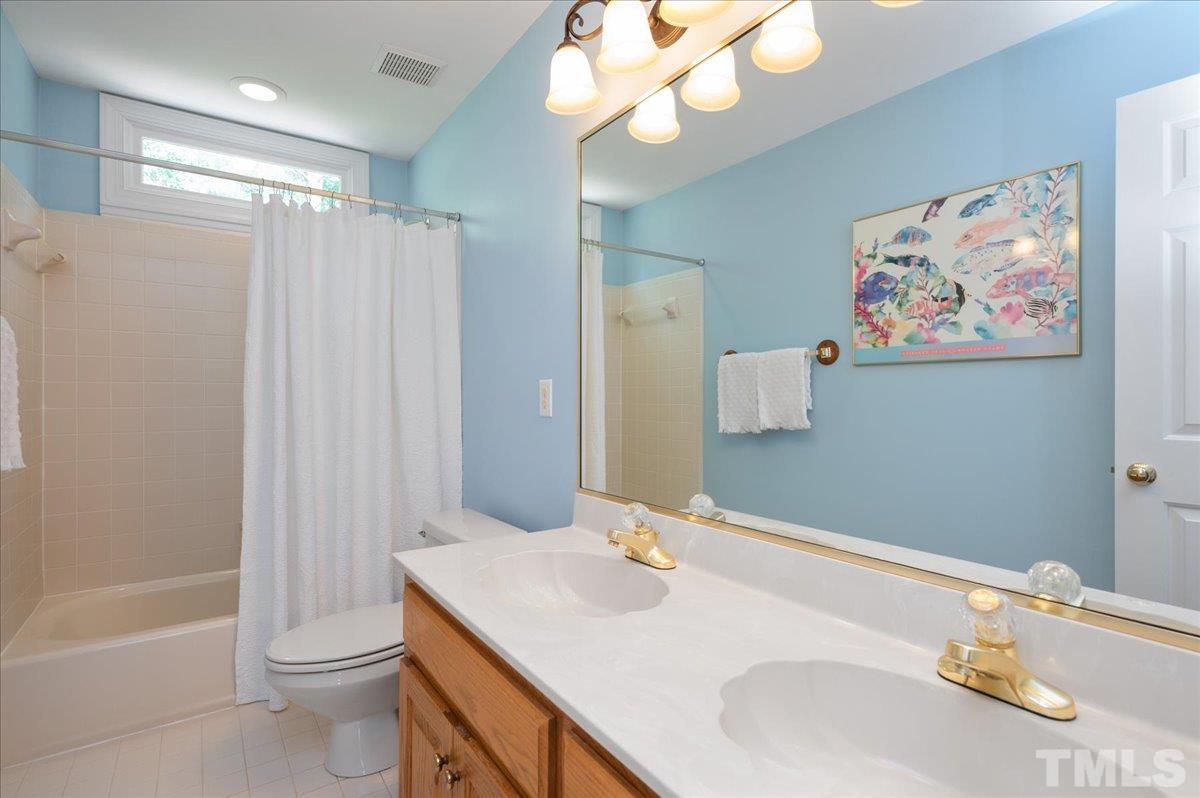 7025 Spring Ridge Road Cary, NC 27518 - Photo 26 of 35 a bathroom with a sink a toilet and shower