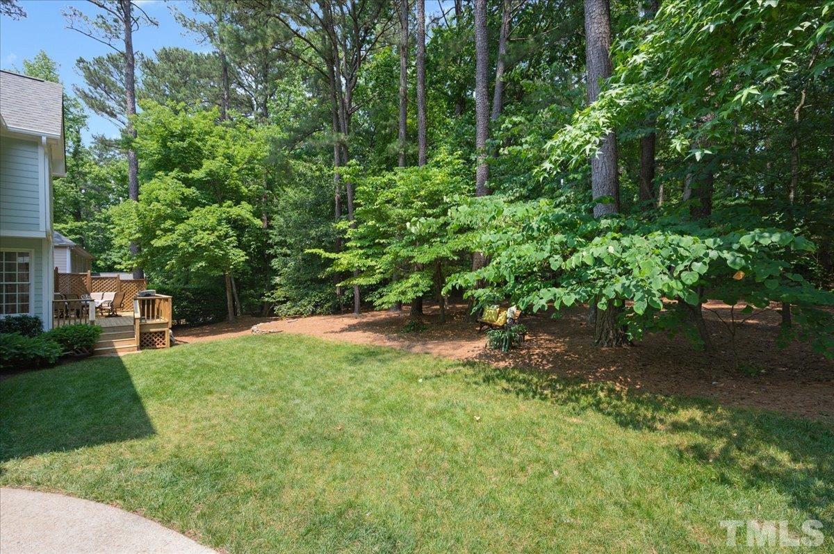 7025 Spring Ridge Road Cary, NC 27518 - Photo 30 of 35 a backyard of a house with lots of green space