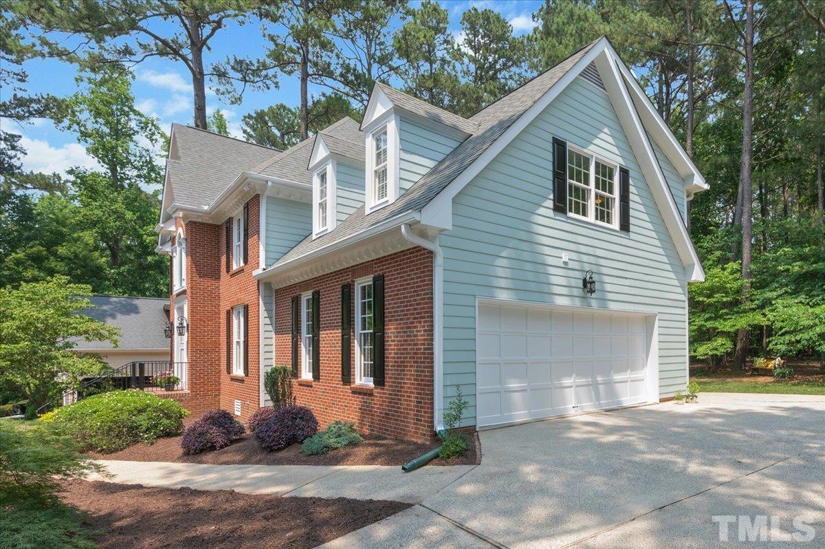 7025 Spring Ridge Road Cary, NC 27518 - Photo 3 of 35 a front view of a house with garden