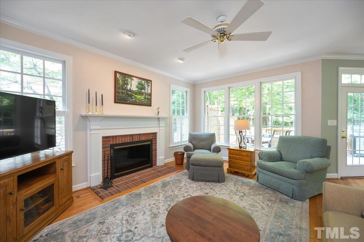 7025 Spring Ridge Road Cary, NC 27518 - Photo 9 of 35 a living room with furniture a flat screen tv and a fireplace