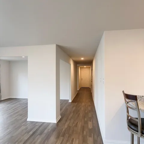 a view of hallway with wooden floor