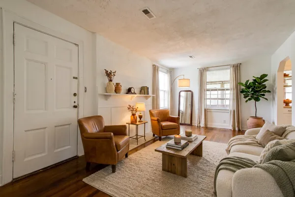 a living room with furniture rug and window