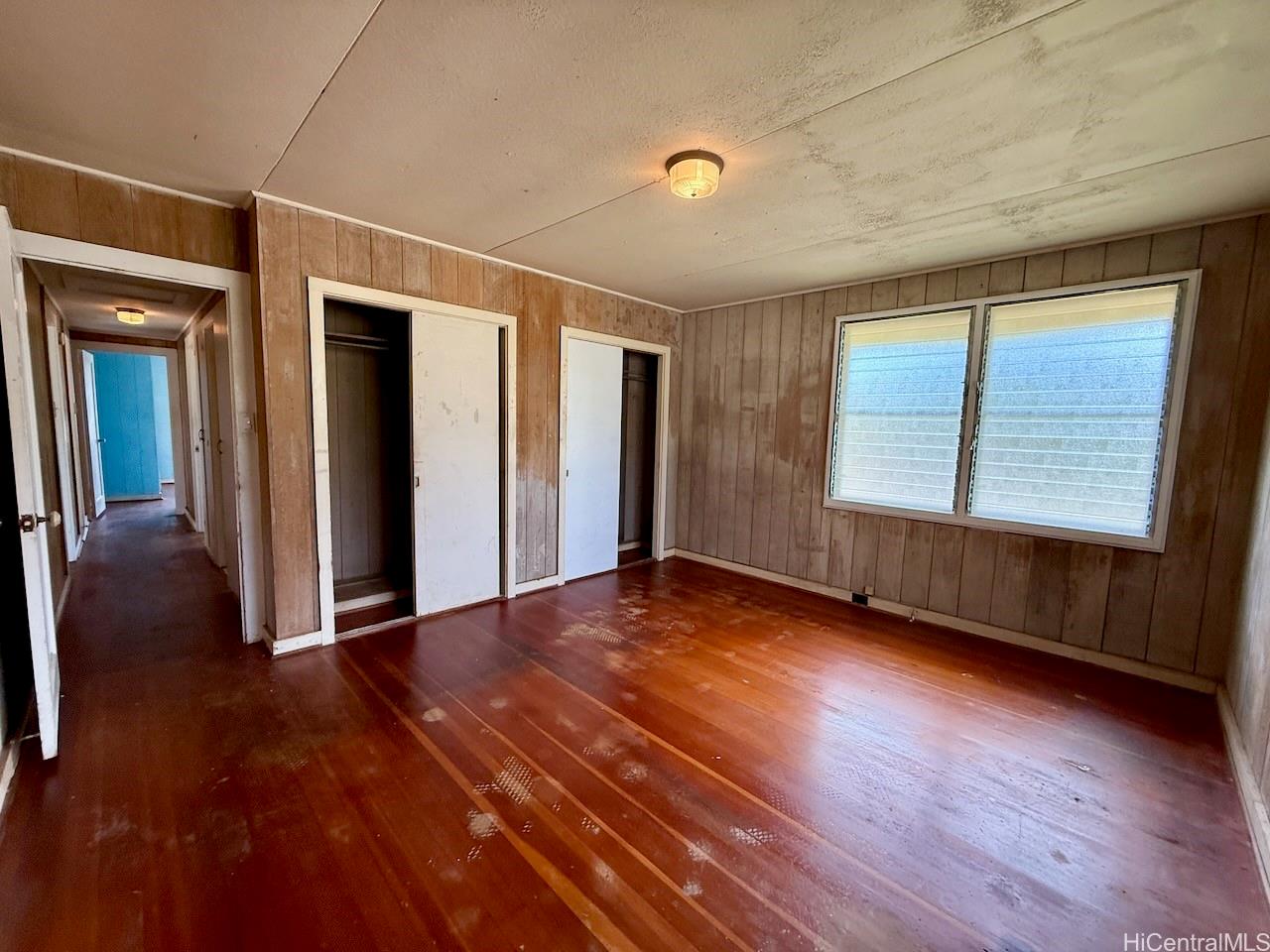 5265 Manauwea Street Honolulu, HI 96821 - Photo 13 of 24 an empty room with wooden floor and windows