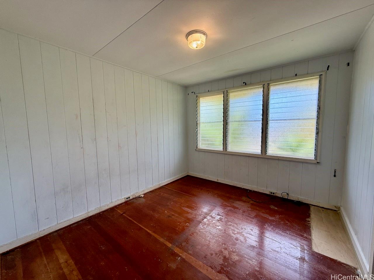 5265 Manauwea Street Honolulu, HI 96821 - Photo 14 of 24 an empty room with wooden floor and windows