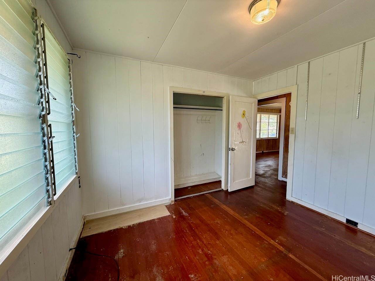 5265 Manauwea Street Honolulu, HI 96821 - Photo 15 of 24 an empty room with wooden floor closet and windows