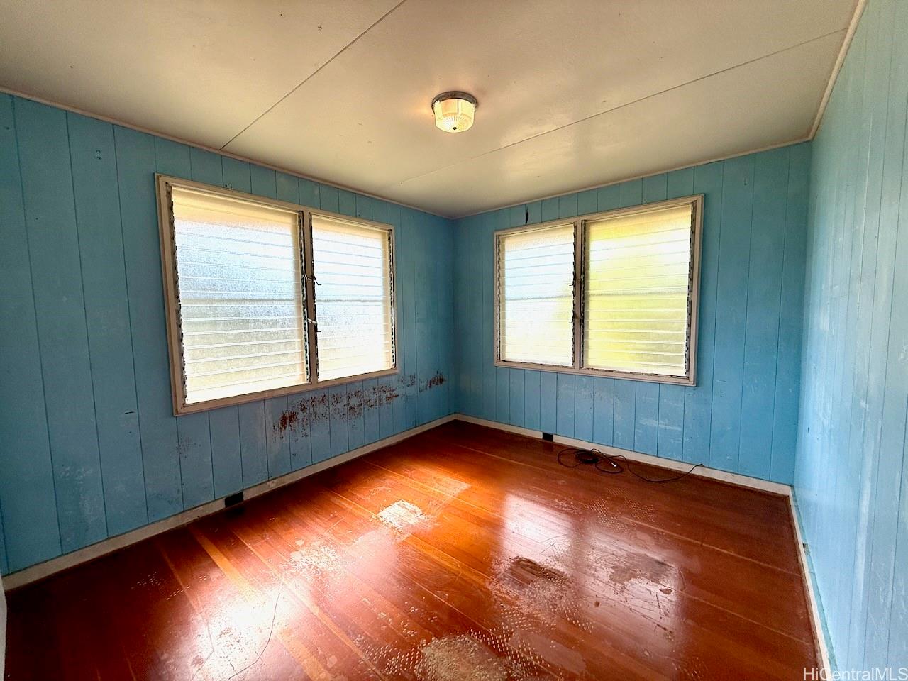 5265 Manauwea Street Honolulu, HI 96821 - Photo 16 of 24 a view of an empty room with wooden floor and a window