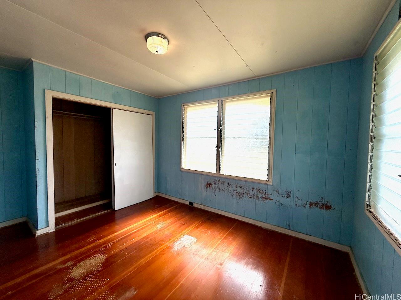 5265 Manauwea Street Honolulu, HI 96821 - Photo 17 of 24 an empty room with wooden floor and windows