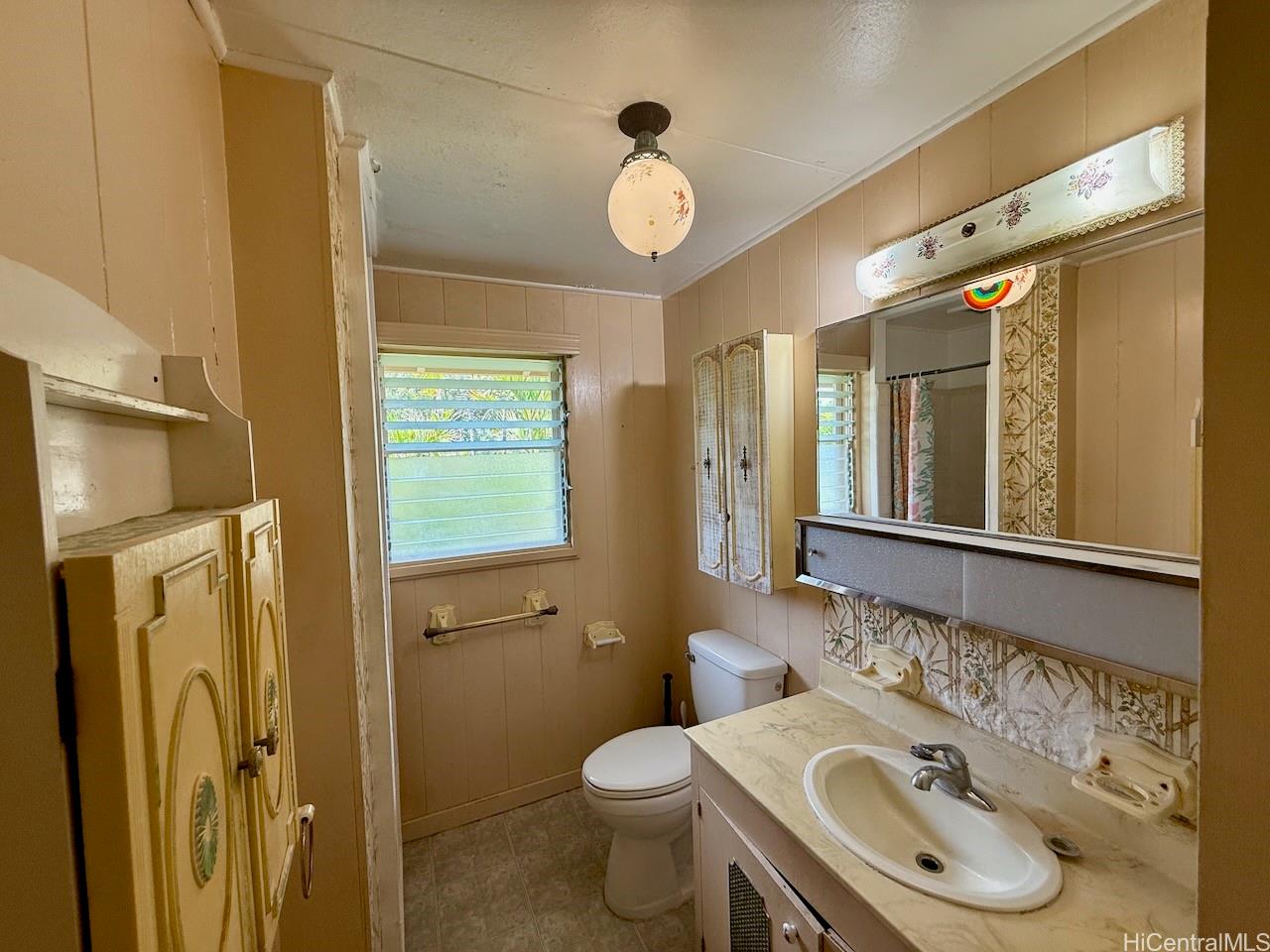 5265 Manauwea Street Honolulu, HI 96821 - Photo 19 of 24 a bathroom with a sink and a mirror