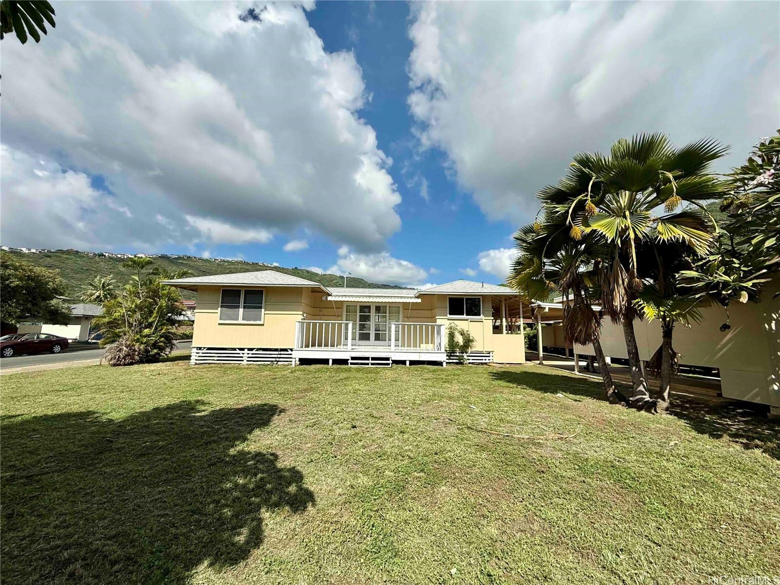 5265 Manauwea Street Honolulu, HI 96821 - Photo 2 of 24 a big yard with table and chairs under an umbrella