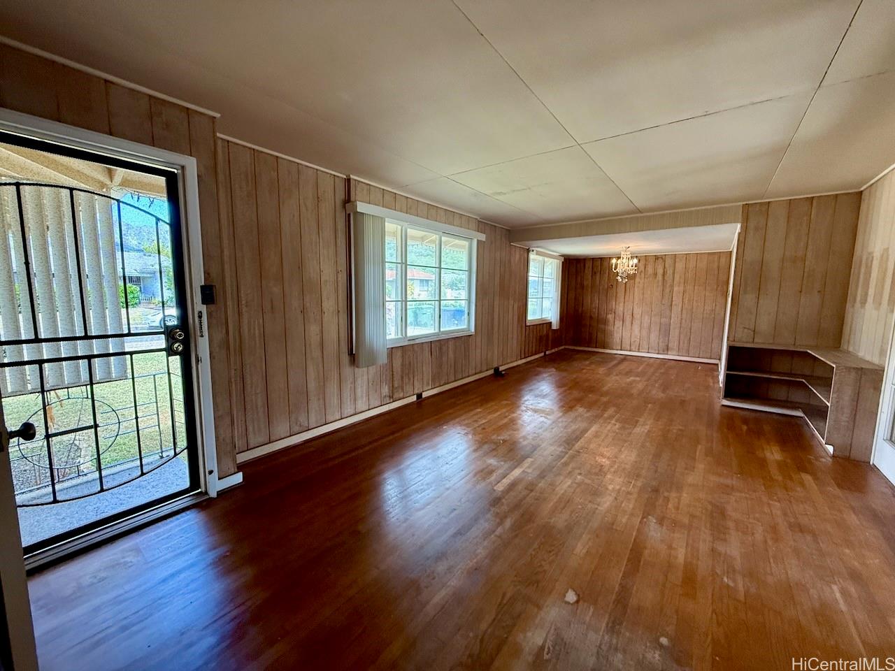 5265 Manauwea Street Honolulu, HI 96821 - Photo 3 of 24 an empty room with wooden floor and windows