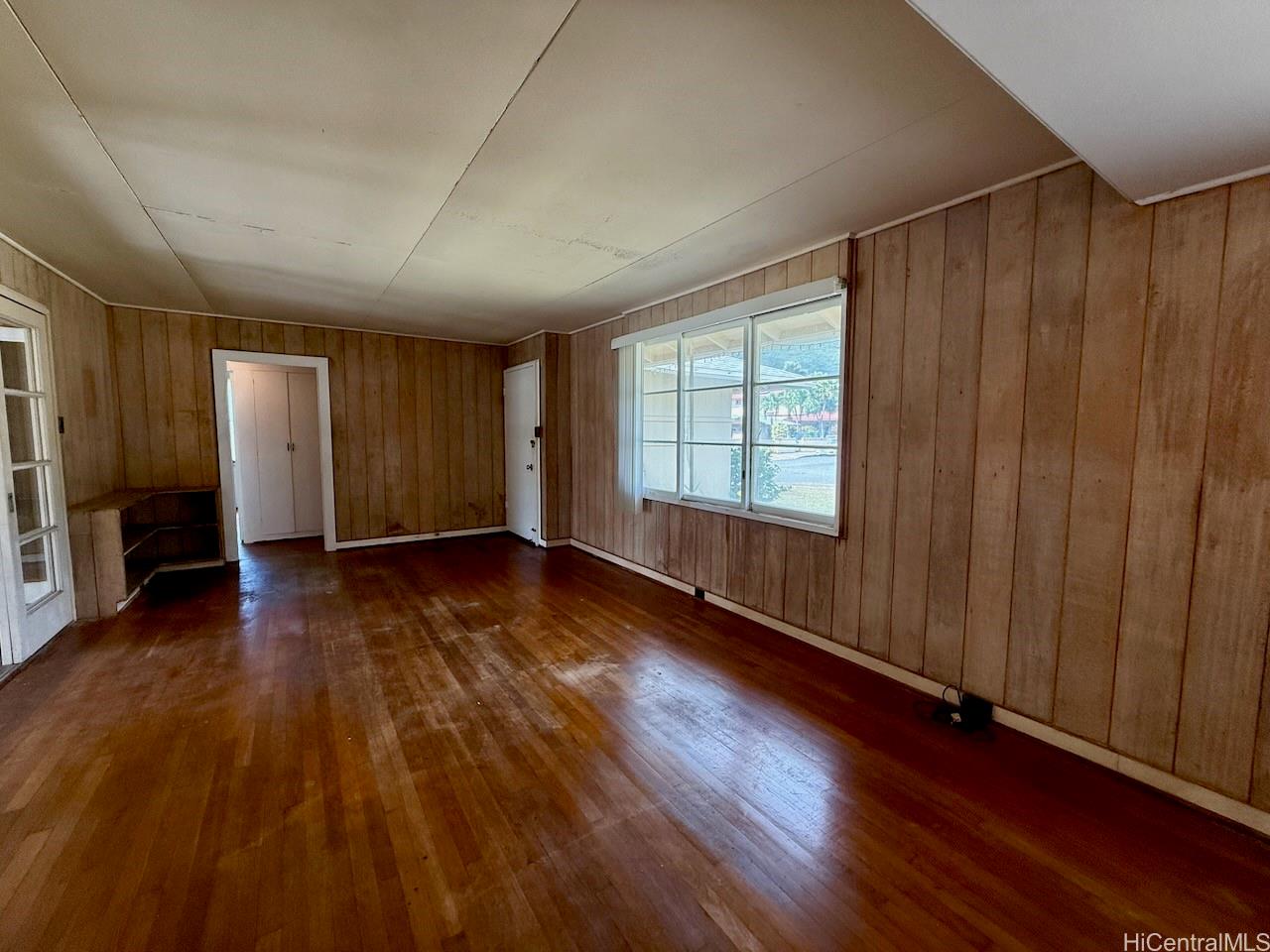 5265 Manauwea Street Honolulu, HI 96821 - Photo 4 of 24 an empty room with wooden floor and windows