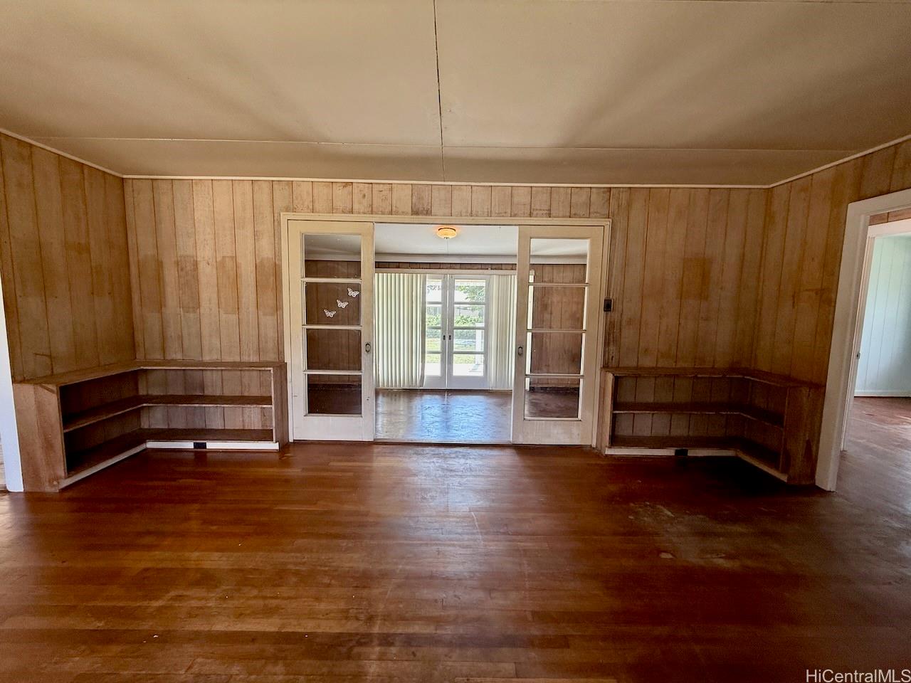 5265 Manauwea Street Honolulu, HI 96821 - Photo 6 of 24 an empty room with wooden floor and windows
