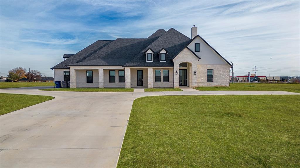 165 Ranch House Road Rockwall, TX 75032 - Photo 8 of 40 a front view of a house with a garden and trees