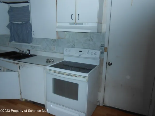 a utility room with sink dryer and washer