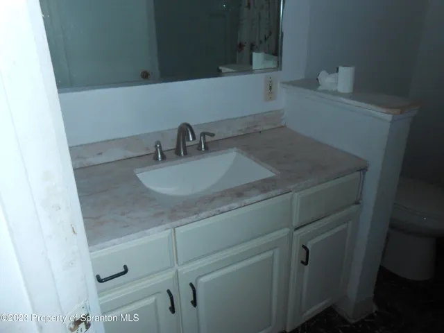 a bathroom with a sink and vanity