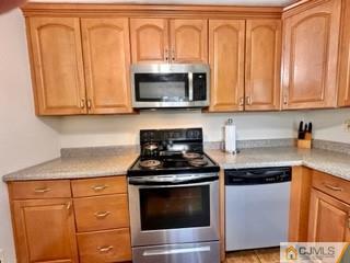 83 Ravine Drive Matawan, NJ 07747 - Photo 12 of 33 a kitchen with stainless steel appliances granite countertop white cabinets and a stove top oven