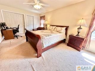 83 Ravine Drive Matawan, NJ 07747 - Photo 20 of 33 a spacious bedroom with a bed and a couch