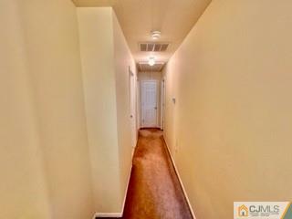 83 Ravine Drive Matawan, NJ 07747 - Photo 25 of 33 a view of a hallway with wooden floor