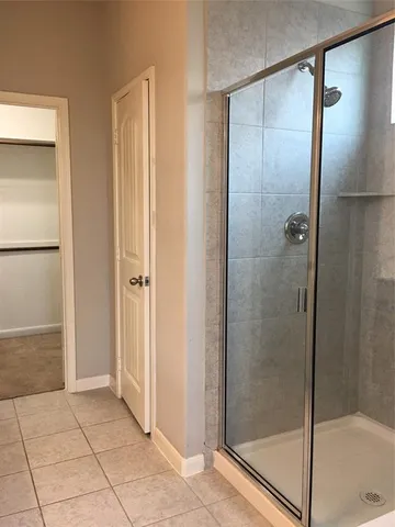 a bathroom with a glass shower door