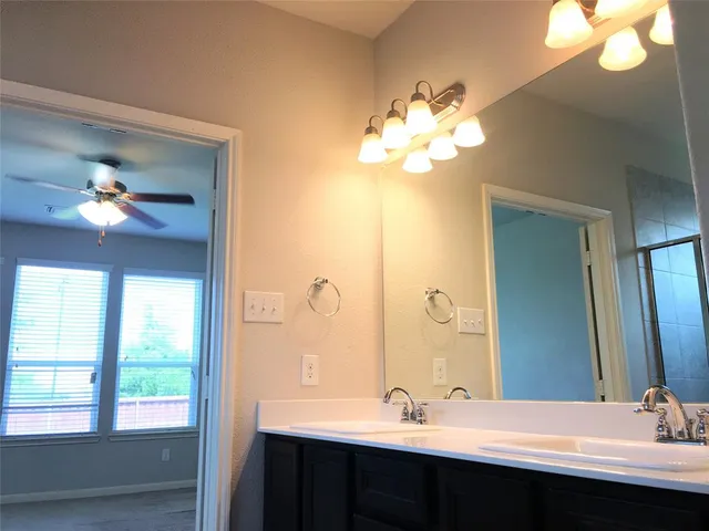 a bathroom with a double vanity sink and a mirror