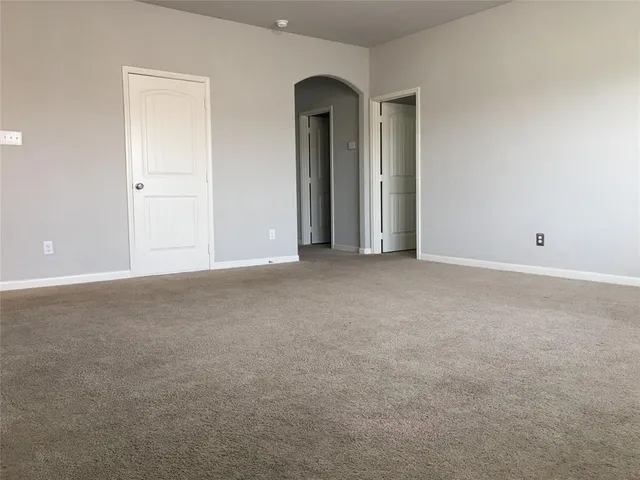 a view of an empty room with glass door