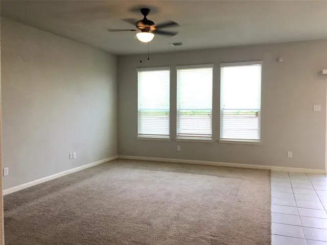 a view of room with a ceiling fan and window