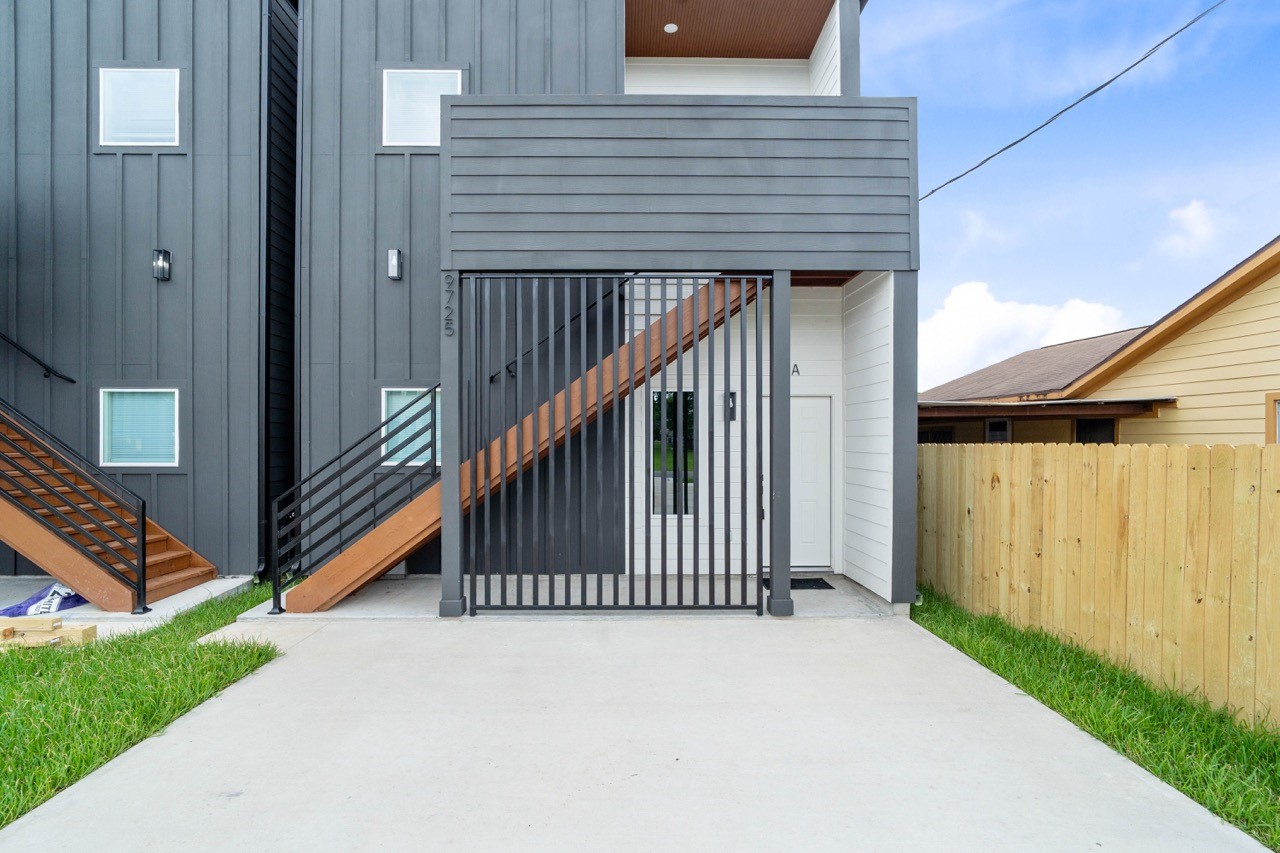 9725 Kerr Street, Unit A Houston, TX 77029 - Photo 2 of 34 Private entry area with modern exterior finishes, fenced side yard, and direct access to the unit, creating a clean and comfortable arrival experience.