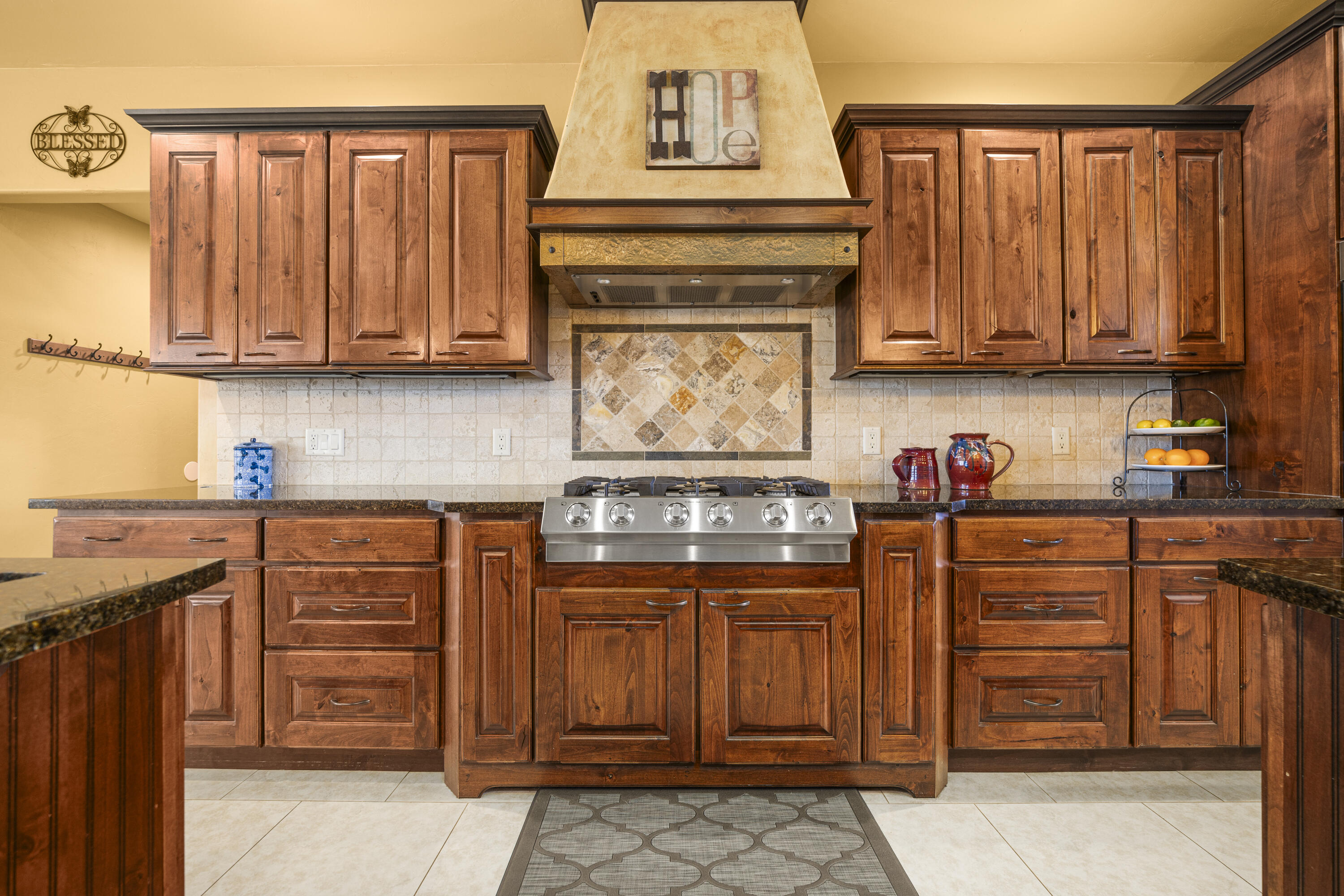 67841 Tumbleweed Road Montrose, CO 81403 - Photo 5 of 21 a kitchen with granite countertop a stove top oven microwave and cabinets