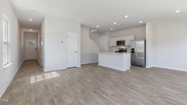 a view of a kitchen with a sink and a refrigerator