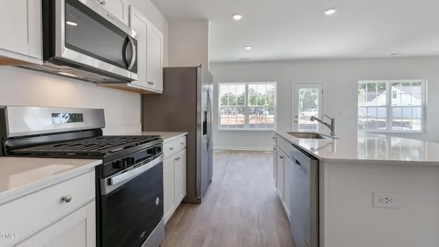 a kitchen with stainless steel appliances granite countertop a stove and a sink