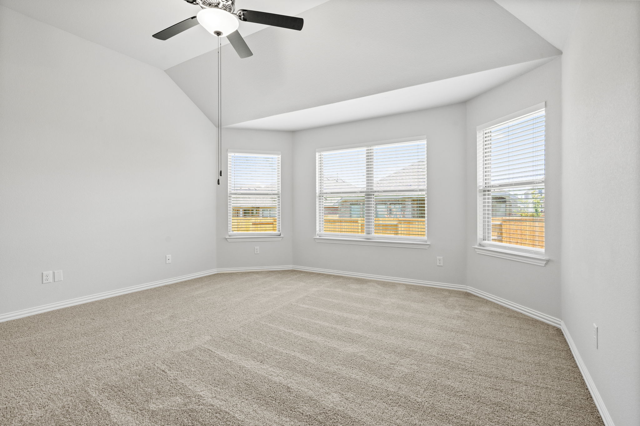341 Fawn Riv Run Kyle, TX 78640 - Photo 10 of 29 an empty room with windows and fan