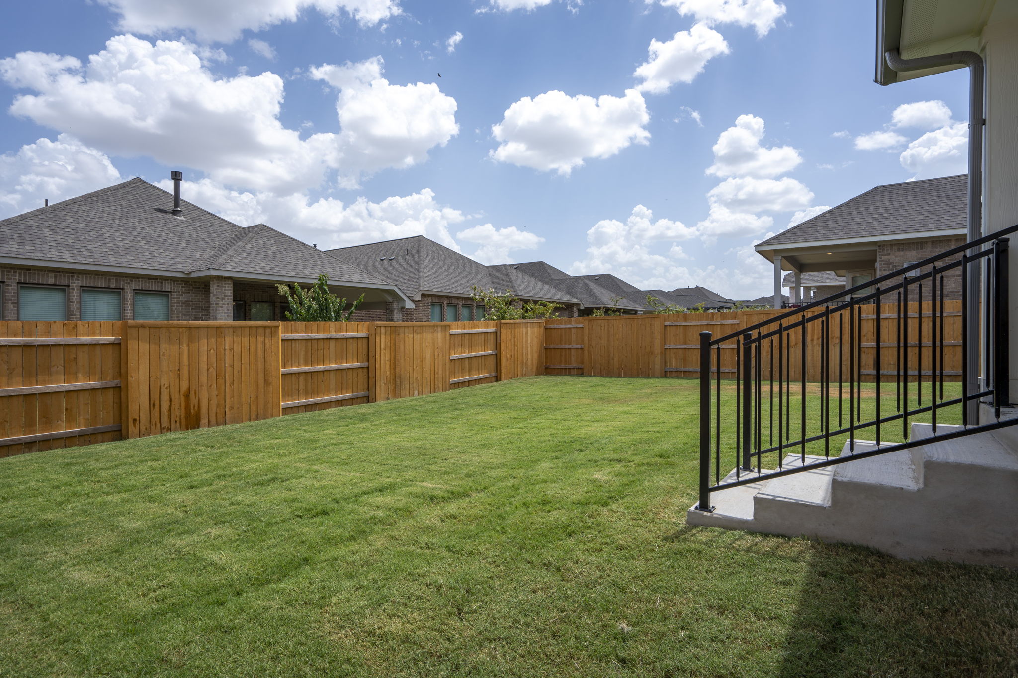 341 Fawn Riv Run Kyle, TX 78640 - Photo 23 of 29 a view of a yard with wooden fence
