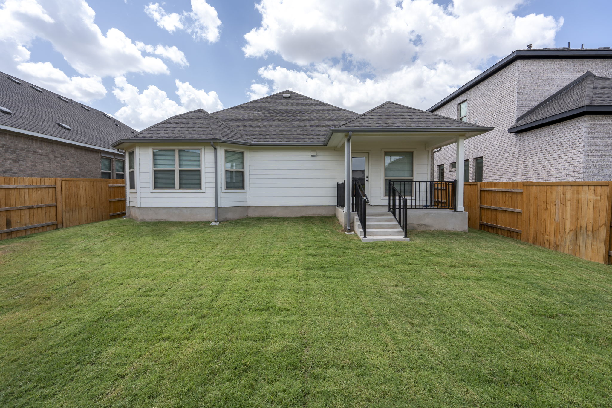 341 Fawn Riv Run Kyle, TX 78640 - Photo 24 of 29 a front view of a house with a garden and plants