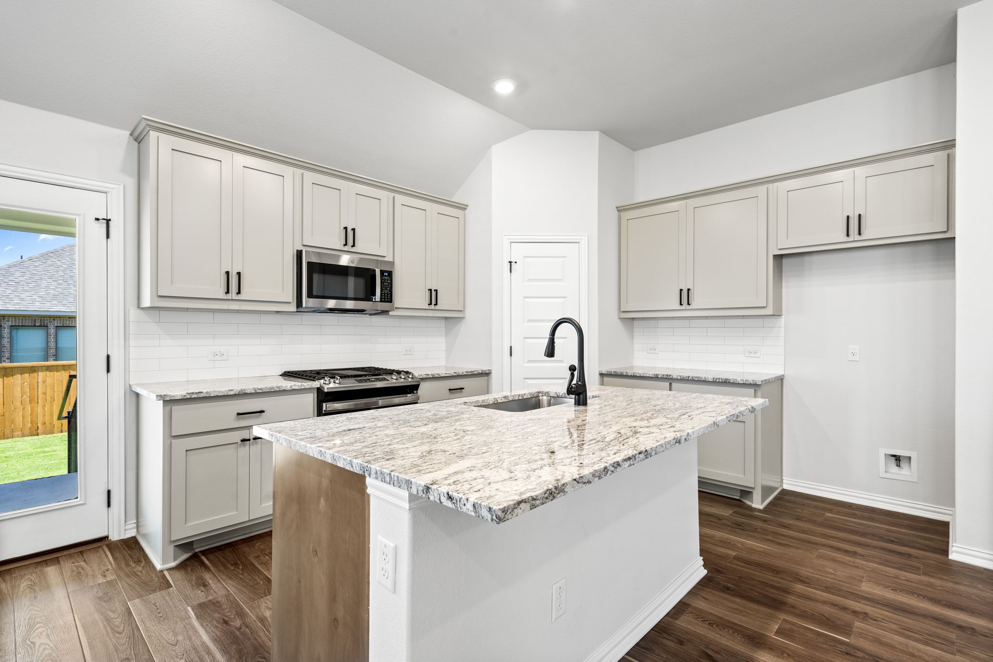 341 Fawn Riv Run Kyle, TX 78640 - Photo 5 of 29 a kitchen with granite countertop a sink stove and refrigerator