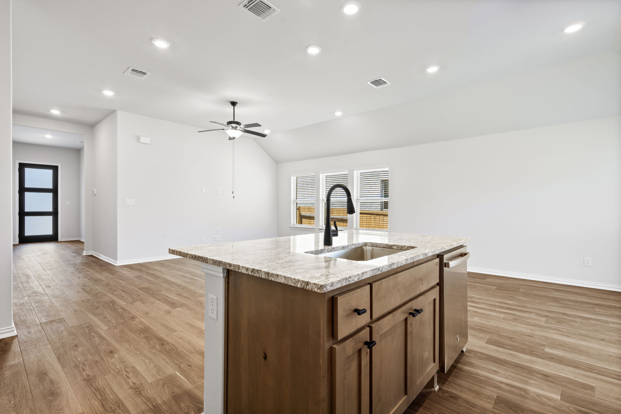 341 Fawn Riv Run Kyle, TX 78640 - Photo 7 of 29 a kitchen with a sink and a ceiling fan