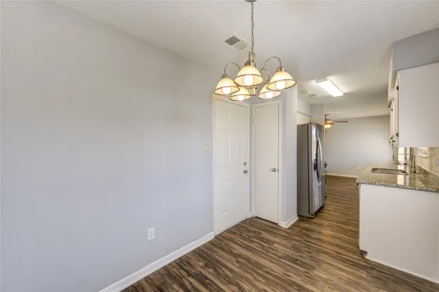 a view of a kitchen from a hallway