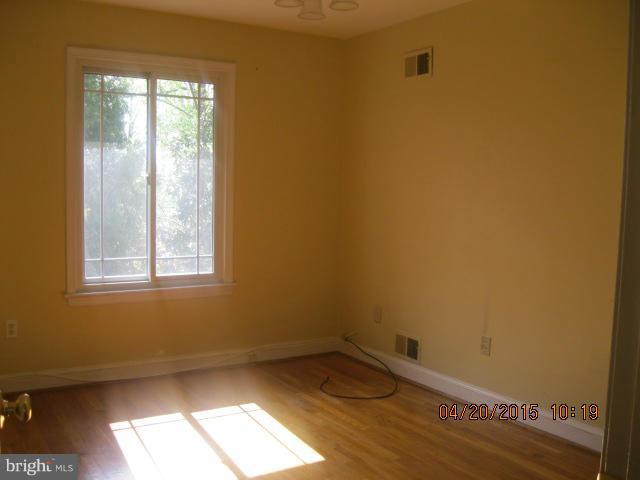 8807 Reading Road Silver Spring, MD 20901 - Photo 11 of 21 a view of empty room with wooden floor and fan