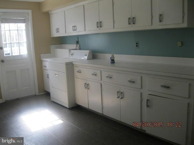 8807 Reading Road Silver Spring, MD 20901 - Photo 21 of 21 a kitchen with cabinets appliances a sink and dishwasher