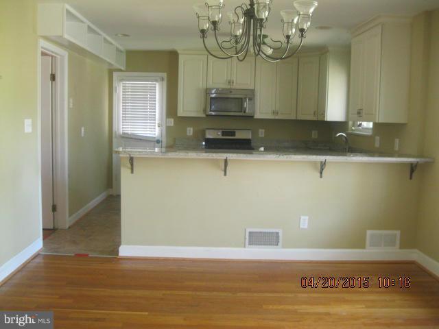 8807 Reading Road Silver Spring, MD 20901 - Photo 5 of 21 a view of a kitchen with sink and wooden floor