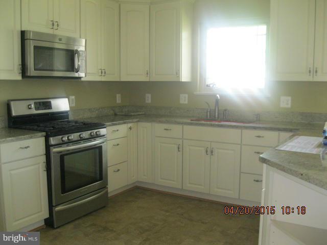 8807 Reading Road Silver Spring, MD 20901 - Photo 7 of 21 a kitchen with granite countertop white cabinets and stainless steel appliances