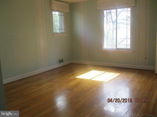 8807 Reading Road Silver Spring, MD 20901 - Photo 9 of 21 an empty room with wooden floor and windows