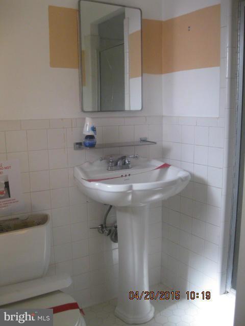 8807 Reading Road Silver Spring, MD 20901 - Photo 10 of 21 a bathroom with a sink and a mirror