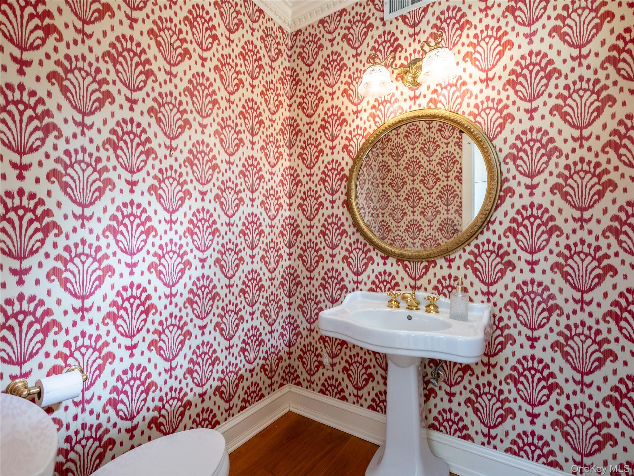 1054 Plandome Road Manhasset, NY 11030 - Photo 11 of 47 a bathroom with a sink and a mirror
